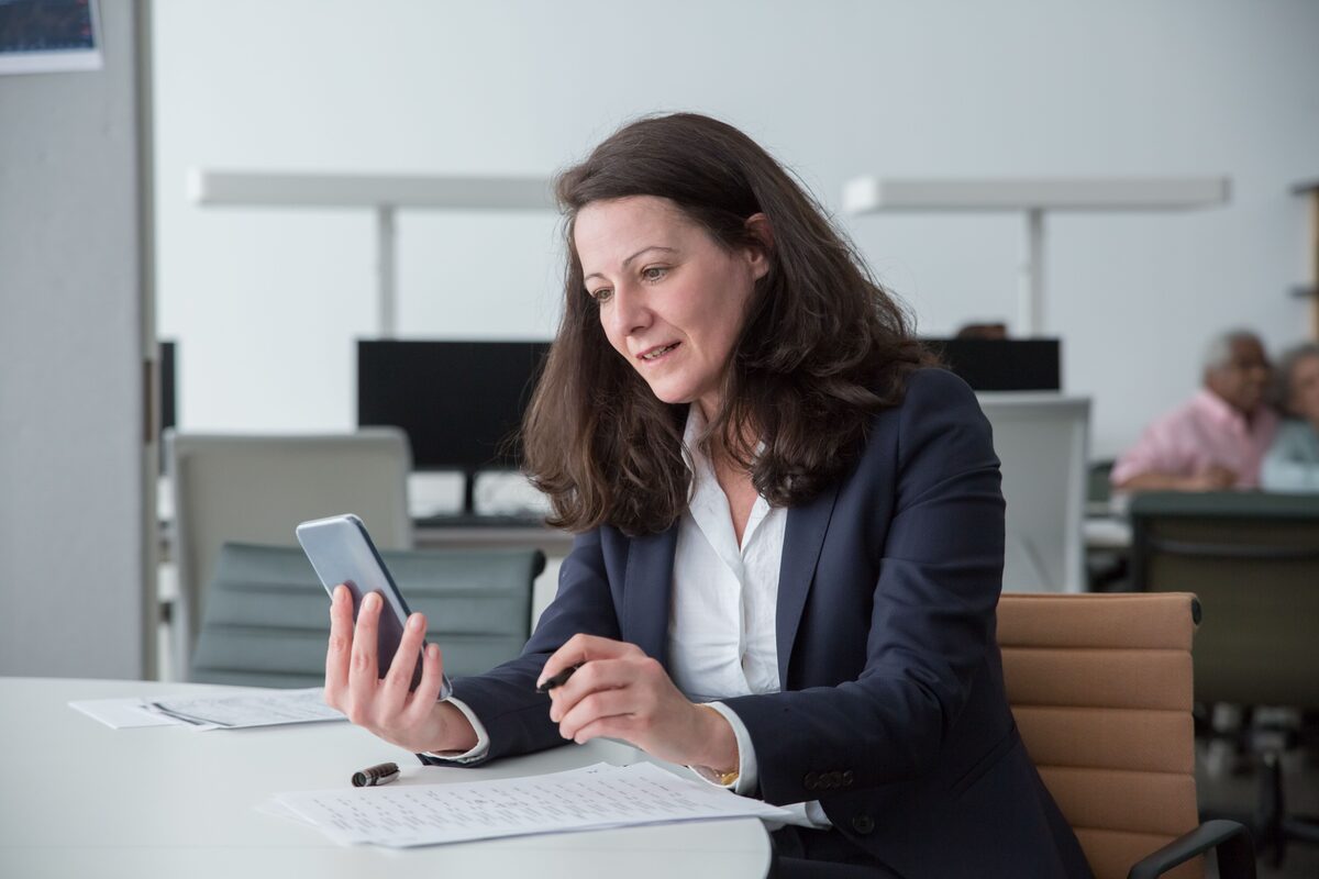Administrator reviewing employee support details on a phone